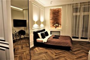 a bedroom with a bed and a television in it at Luxury Jacuzzi Apartment in Kraków