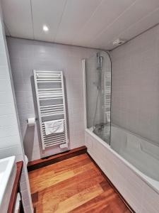 a bathroom with a shower and a bath tub at Terres de France - Domaine du Palais in Saint-Lizier