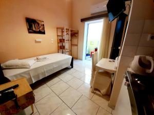 a small room with a bed and a bathroom at Anthemio in Loutraki