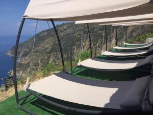 a row of chairs sitting on top of a beach at Il Borgo Di Campi in Riomaggiore