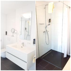 a white bathroom with a shower and a sink at Villa Viktoria 3 in Ingolstadt