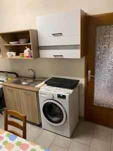 a kitchen with a washing machine and a sink at B&B LOKEV Sezana in Lokev