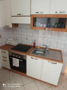 a kitchen with a sink and a stove at Apartment Karlo in Supetar