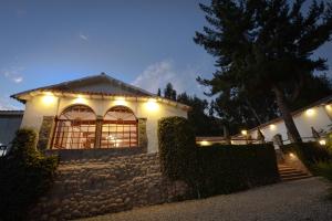 a house with lights on a stone wall at Palacio Manco Capac by Ananay Hotels in Cusco