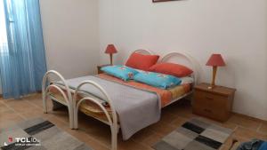a bedroom with a bed with two pillows on it at trivanio semplice in Sassari