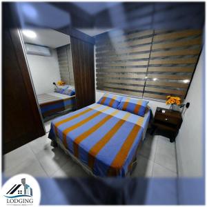 Llit o llits en una habitació de Apto Moderno con Piscina de borde infinito