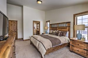 a bedroom with a large bed and a television at Luxe Rocky Mtn Retreat with Hot Tub - By Winter Park in Tabernash