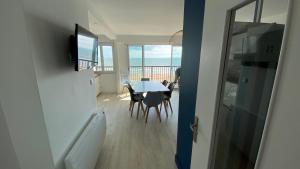 a dining room with a table and a view of the ocean at Appartement 3 chambres, panoramique vue océan in Saint-Jean-de-Monts