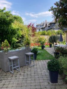 a patio with two stools and some plants at Le Mascaret in Deauville