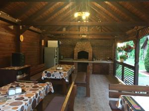 a dining room with two tables and a kitchen at Casa Bambi in Sovata