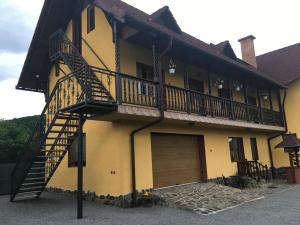 a building with a staircase on the side of it at Casa Bambi in Sovata