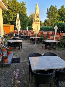 a restaurant with tables and chairs and umbrellas at Hotel Sankt Lorenz in Lübeck