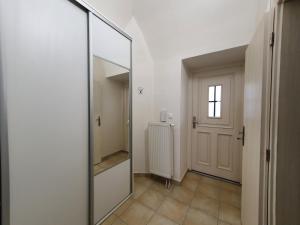 a hallway with a large mirror and a door at apartmány LEVOČA in Levoča