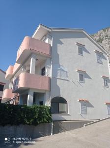 a large white building with windows on the side of it at Apartments Dakovic M in Kotor
