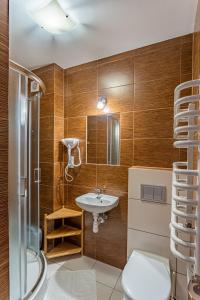 a bathroom with a sink and a shower at Domek Plaster Miodu in Istebna