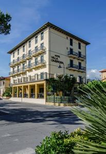 a large white building on the side of a street at Hotel Villa Ombrosa in Marina di Pietrasanta