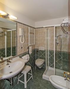 a bathroom with a sink and a toilet and a shower at Hotel Villa Ombrosa in Marina di Pietrasanta