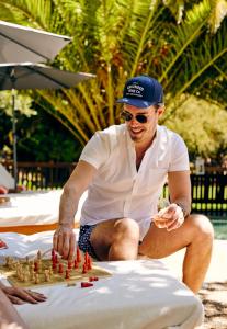 a man sitting on the beach playing chess at boon hotel + spa - adults only in Guerneville