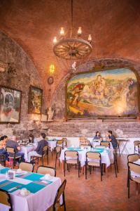 a group of people sitting at tables in a restaurant at Hotel Hacienda de Cobos in Guanajuato