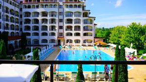 a hotel with a swimming pool in front of a building at Апартамент Сънрайз Обзор - Apartment Sunrise Obzor in Obzor