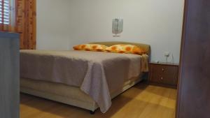 a bed with two pillows on it in a bedroom at Apartman Nina in Makarska