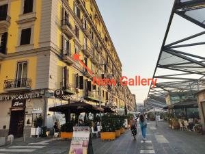 una calle con un edificio con un cartel que lee una nueva galería en New Gallery, en Nápoles