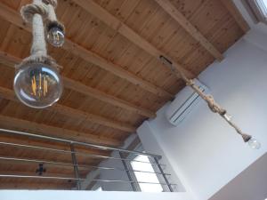 a rope hanging from a ceiling with a light fixture at KTIMA MORAITI - Seaside Houses in Katerini +84 photos