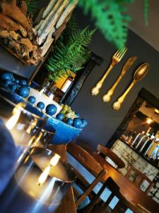 a table with a blue bowl on top of it at The Malthouse in Halifax