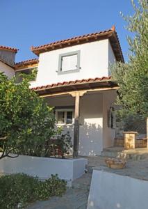 a small white house with a window and a door at Cretan Country house in Áyios Spirídhon