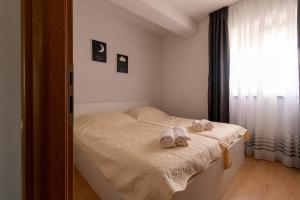 a bedroom with a bed with towels on it at Apartmani Olivia in Bibinje +53 photos