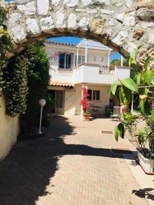 a building with an archway in front of a house at Sea view front beach apartment deluxe near Nice airport in Cagnes-sur-Mer
