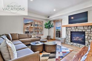 a living room with a couch and a fireplace at White Spruce Lodge by Spring Creek Vacations in Canmore