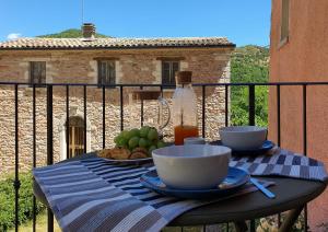 a table with bowls and plates of food on a balcony at Agriturismo Cardella in Piobbico