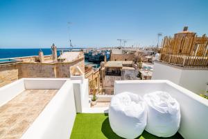 a view of the city from the roof of a building at Tre Archi Suite & Relais in Polignano a Mare