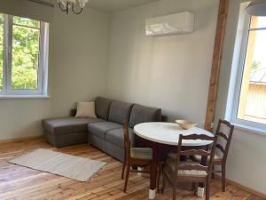 a living room with a couch and a table with chairs at Lahe koht in Haapsalu