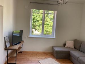 a living room with a couch and a window at Lahe koht in Haapsalu