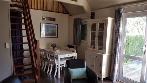 a dining room with a table and chairs and a window at COTTAGE - Lac du Causse in Chasteaux