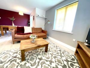 a living room with a couch and a coffee table at Home Crowd Luxury Apartments - Grangefield House in Cantley