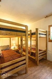 a bedroom with two bunk beds and a room with at Le chalet d'Isis in Villarodin-Bourget