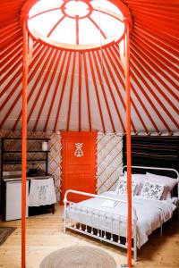 um quarto com uma cama de dossel numa tenda em Jurta Kołbielska em Podgórzno