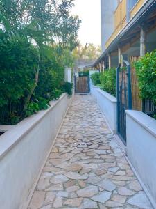 a stone walkway next to a house with a fence at Art Village Residence in Bisceglie