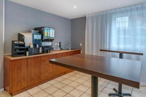 a dining room with a table and a television at Econo Lodge in Montreal
