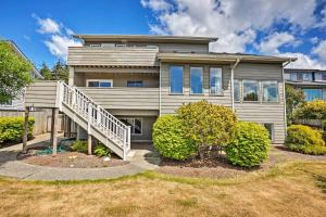 a house with a staircase in front of it at Chic Coos Bay Home with Pacific Ocean Views! in Coos Bay