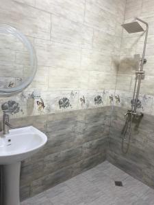 a bathroom with a sink and a shower at Guest House ETM in Makhinjauri