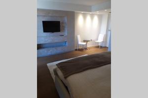 a bedroom with a bed and a tv on a wall at For Families Only - Casa Nora Novigrad in Novigrad Istria