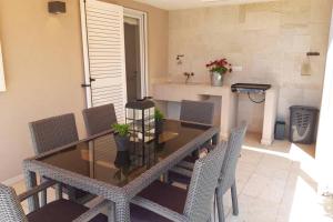 a dining table and chairs in a room with a table at For Families Only - Casa Nora Novigrad in Novigrad Istria