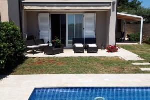 a house with chairs and a swimming pool at For Families Only - Casa Nora Novigrad in Novigrad Istria