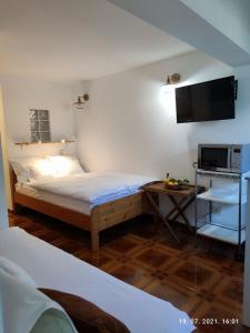 a bedroom with a bed and a tv on the wall at SUMMER TIME in Premantura