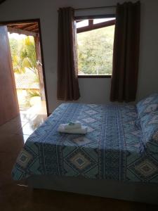 Ένα ή περισσότερα κρεβάτια σε δωμάτιο στο Pousada Cachoeirinha