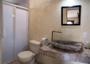 a bathroom with a marble sink and a toilet at Hotel Casa del Arbol in Bernal +46 photos